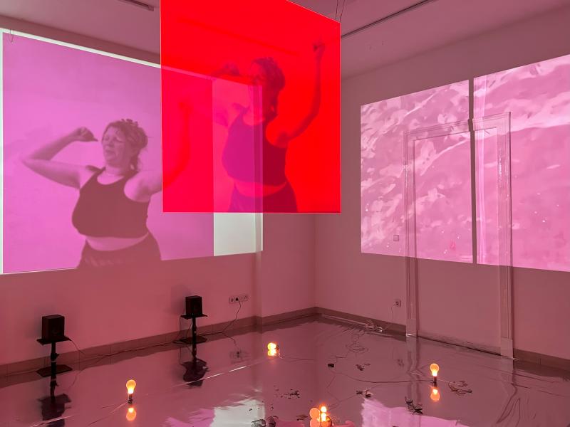 Pink video installation with perspex, broken glass and a reflective floor by Isabella Chydenius