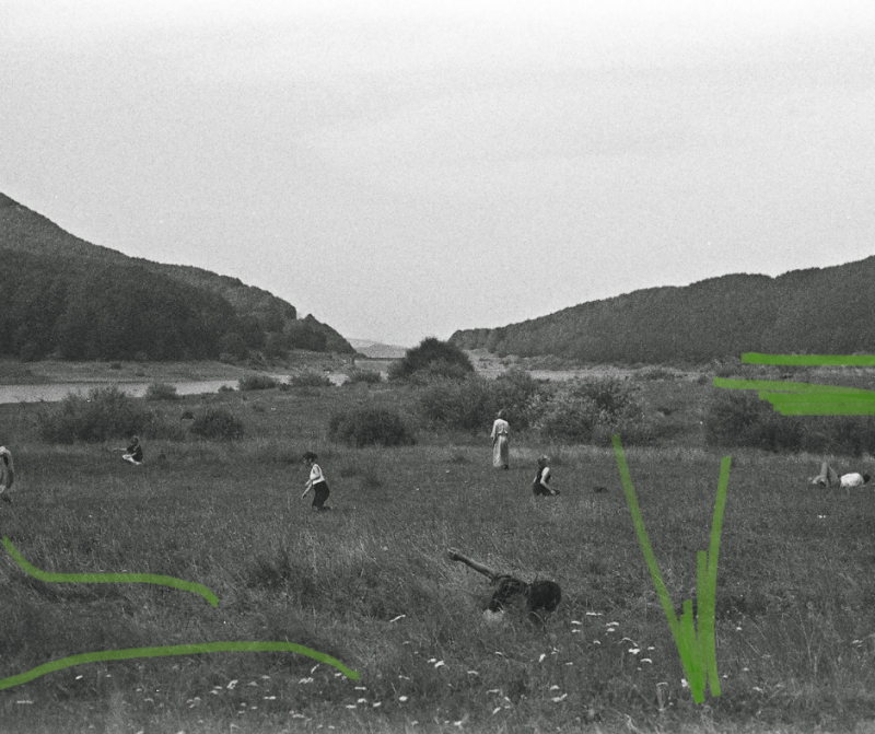 dancers on a field between the mountains