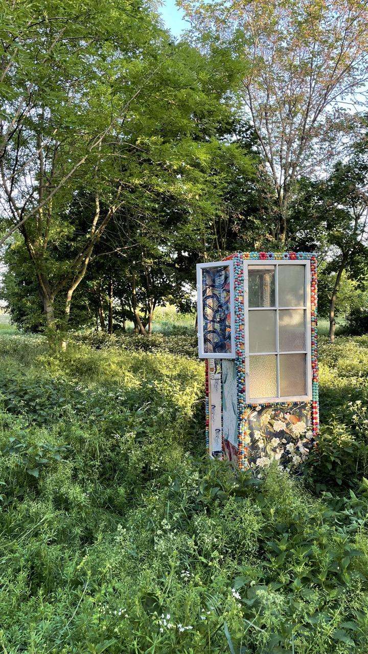 Photo of the Travel Poems Teleporter Booth in a forest