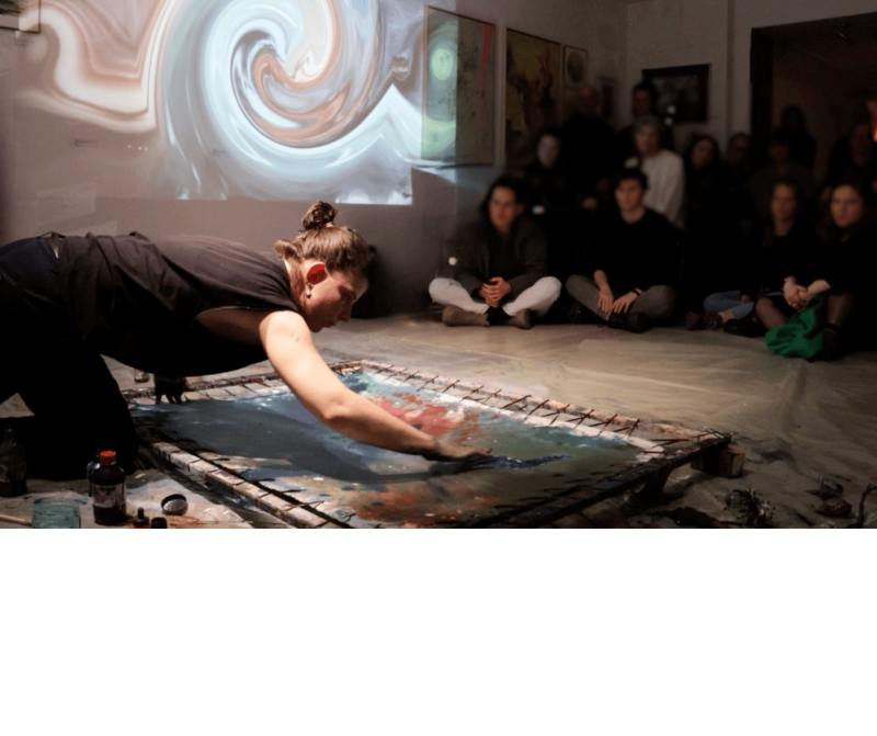 A footage of live performance in which the painter creating colors and images on canvas, while we see the manipulated version of the shapes and colors on the wall which is created by the videoartist as live.