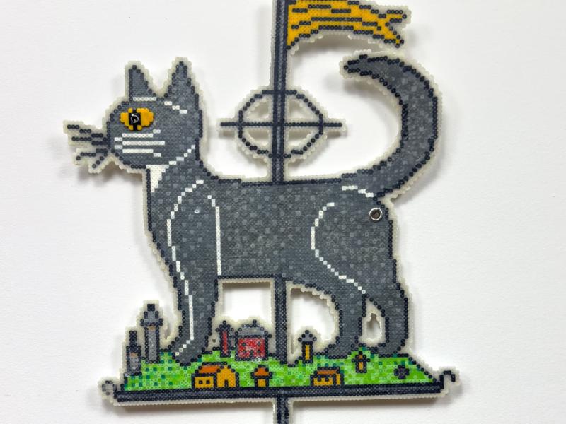 A weather vane of a grey cat