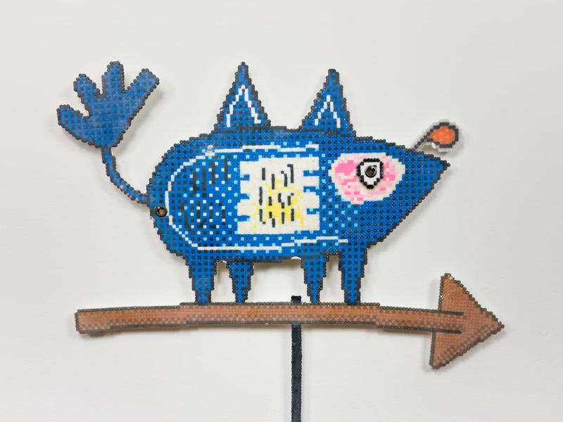 A weather vane featuring a blue pig