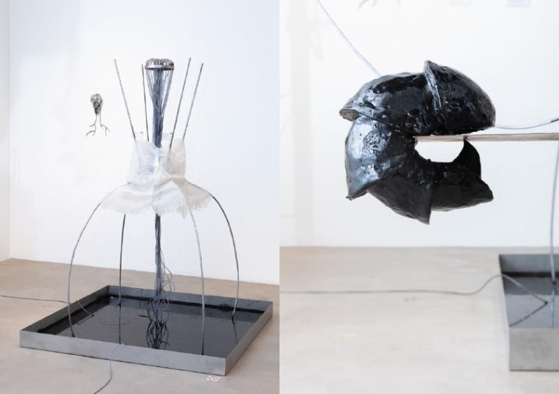 Steel structure with silicone skin standing on metal aquarium filled with black liquid. Resin sculpture on steel structure.