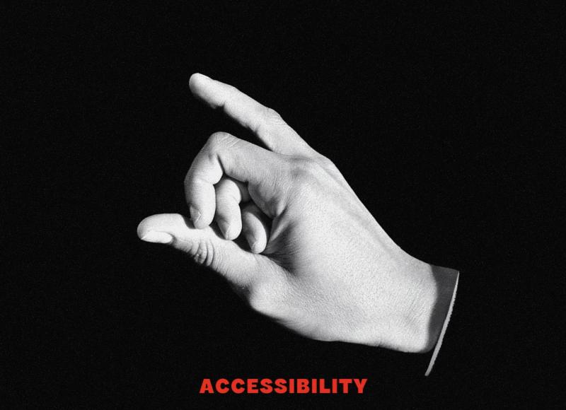 A single hand forms a delicate gesture with the thumb and fingers partially curled while the index finger extends upward. The hand is illuminated against a dark background, and the word “ACCESSIBILITY” appears in bold red text below the hand.