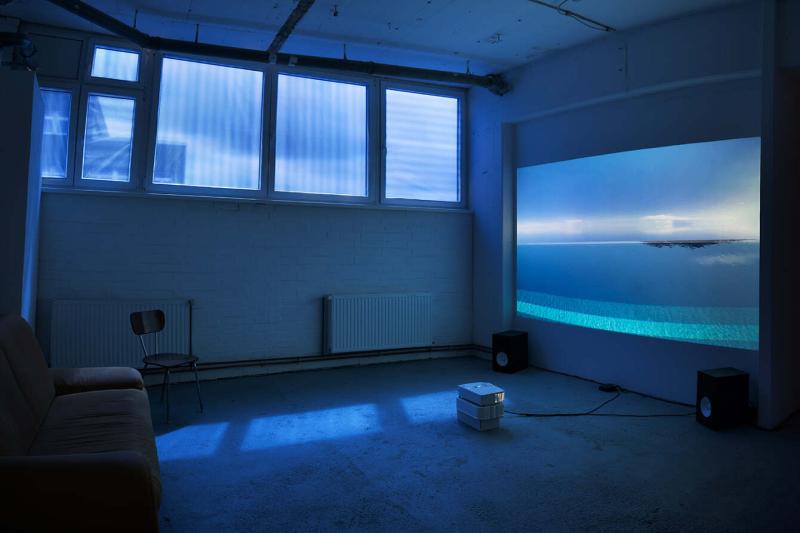 An exhibition room with a video projection.