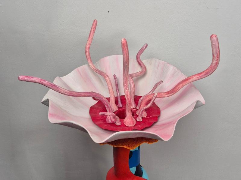 Colorful sculpture resembling a sea anemone with pink tentacle