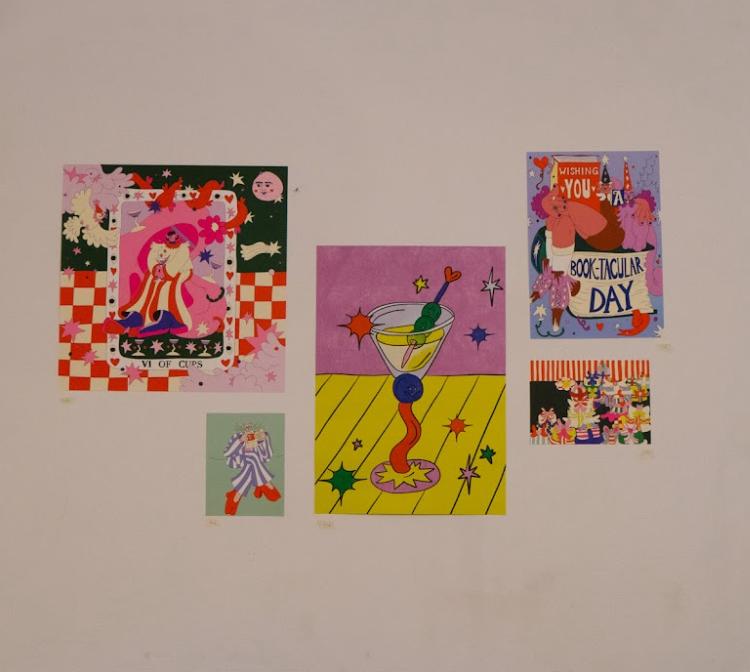 5 posters on a wall of various size